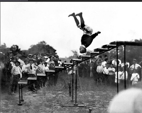 Alexander Patty balances on head and jumps up staircase