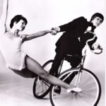 Ola and Barbro Nordstrom perform a balance trick on a bicycle