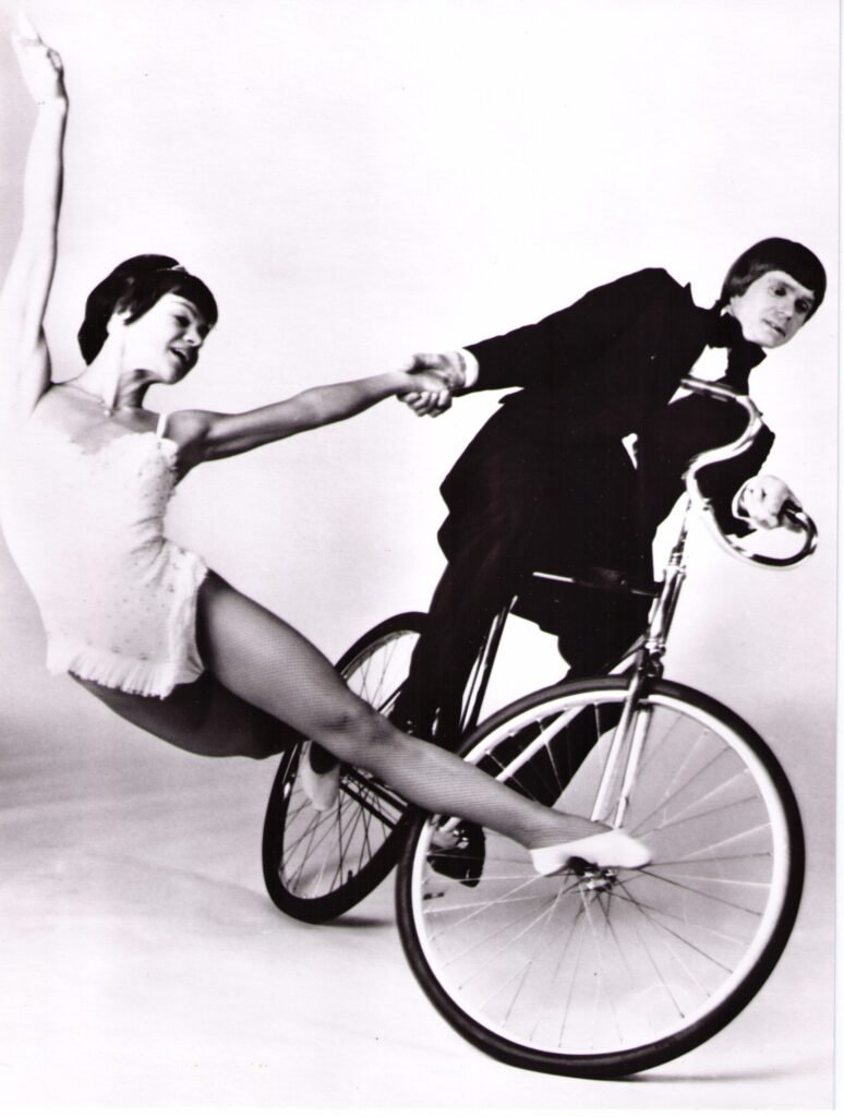 Ola and Barbro Nordstrom perform a balance trick on a bicycle