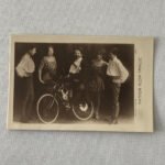 family photo of five people with man sitting on bicycle