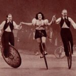 three trick unicyclists perform on stage